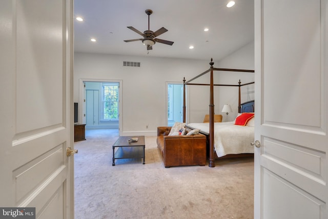 carpeted bedroom featuring ceiling fan with notable chandelier