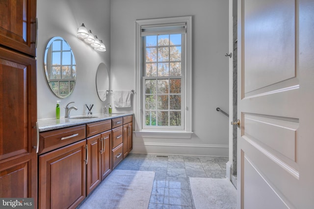 bathroom with vanity, tile flooring, and plenty of natural light