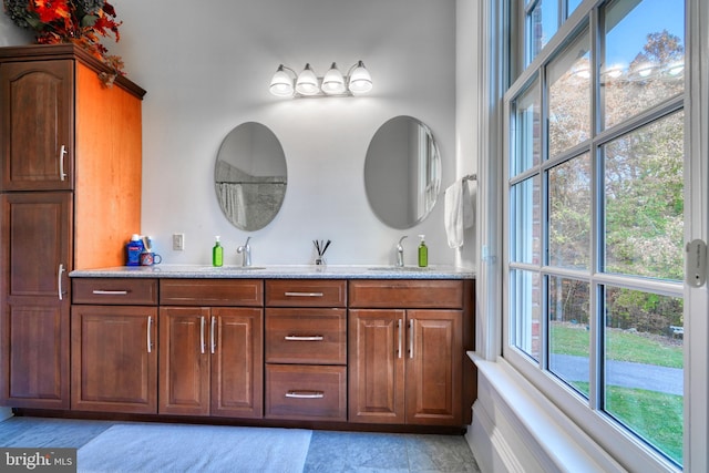 bathroom with double sink vanity and tile flooring