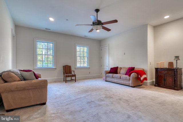 living room with ceiling fan and light colored carpet