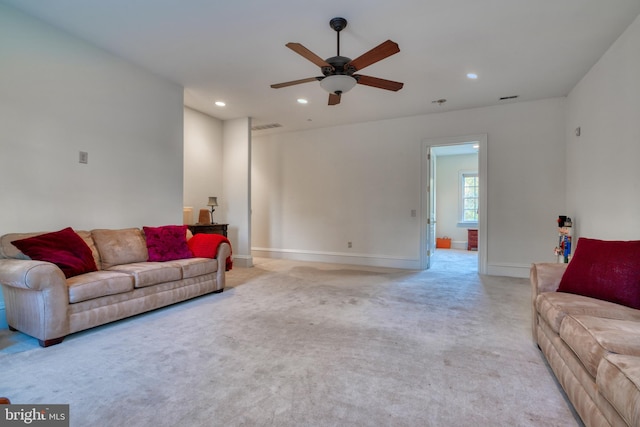 carpeted living room with ceiling fan