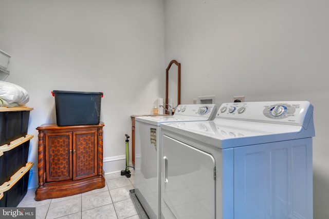 laundry room featuring light tile floors and washer and dryer