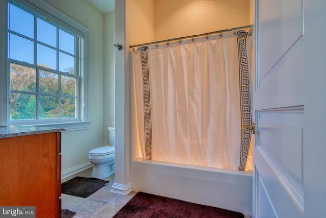 full bathroom with vanity, toilet, tile floors, and shower / bath combo with shower curtain