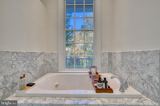 bathroom with a relaxing tiled bath