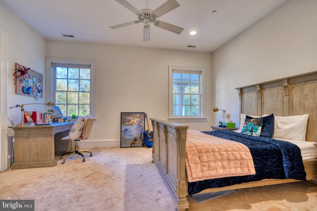 carpeted bedroom featuring ceiling fan and multiple windows