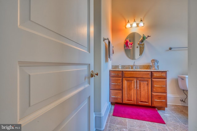 bathroom featuring tile floors, toilet, and vanity