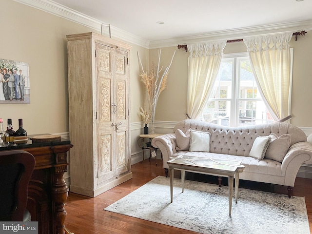 sitting room with hardwood / wood-style flooring and crown molding