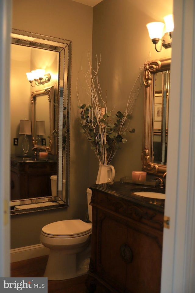 bathroom featuring vanity and toilet