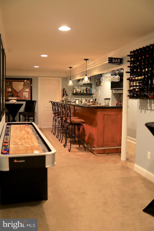 bar with light carpet, pendant lighting, and crown molding