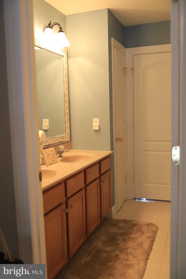 bathroom with tile patterned floors and vanity