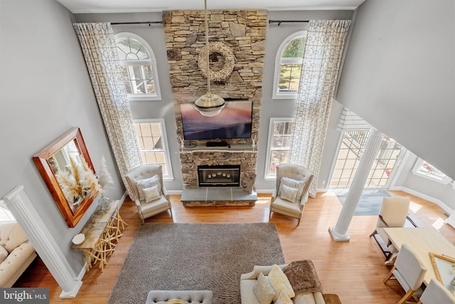 living room with a fireplace, hardwood / wood-style flooring, and plenty of natural light