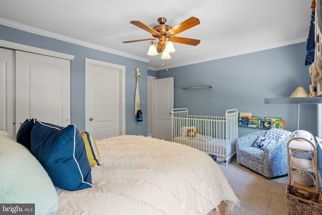 carpeted bedroom featuring ceiling fan and ornamental molding