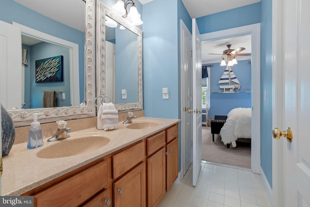 bathroom with tile patterned flooring, vanity, and ceiling fan