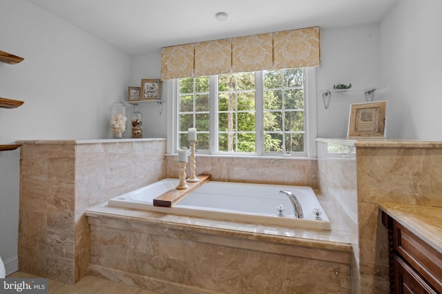 bathroom with tiled bath, tile patterned flooring, and vanity