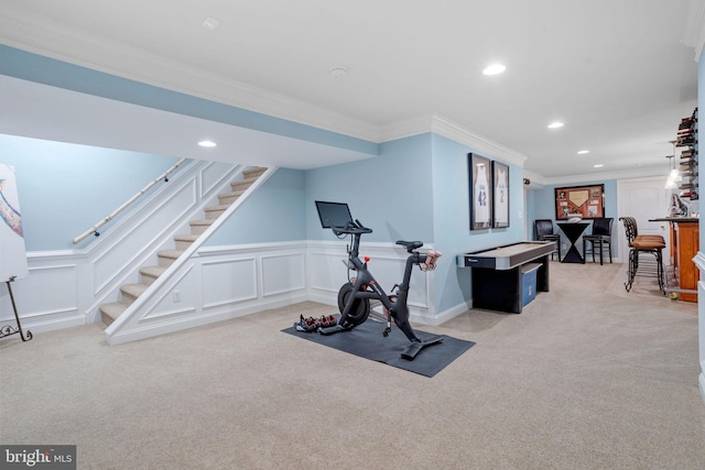 workout room with light carpet and ornamental molding