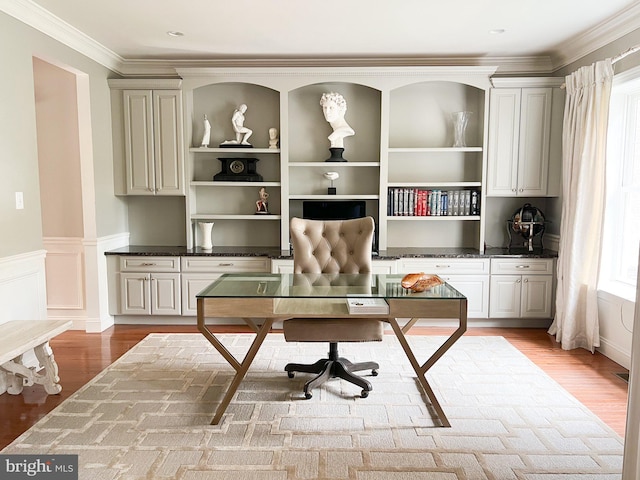 office featuring light wood-type flooring and ornamental molding