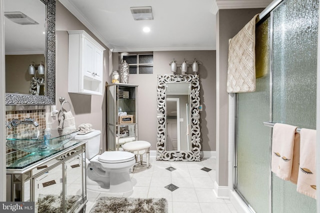 bathroom featuring tile patterned floors, a shower with shower door, and crown molding