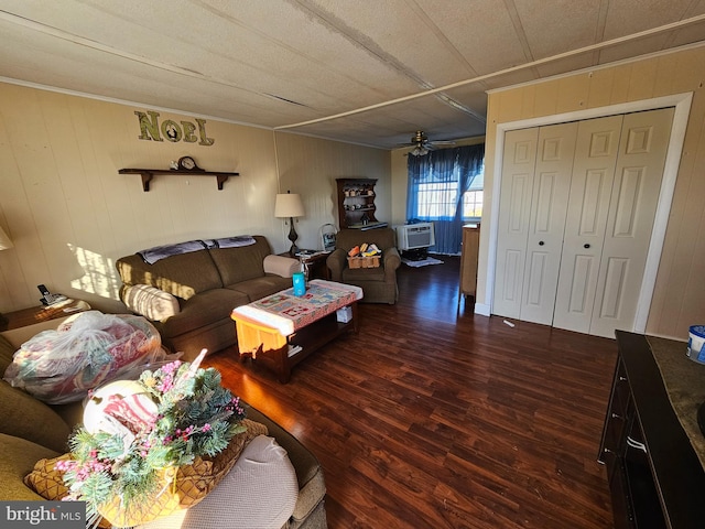 living room with ceiling fan and dark wood-type flooring