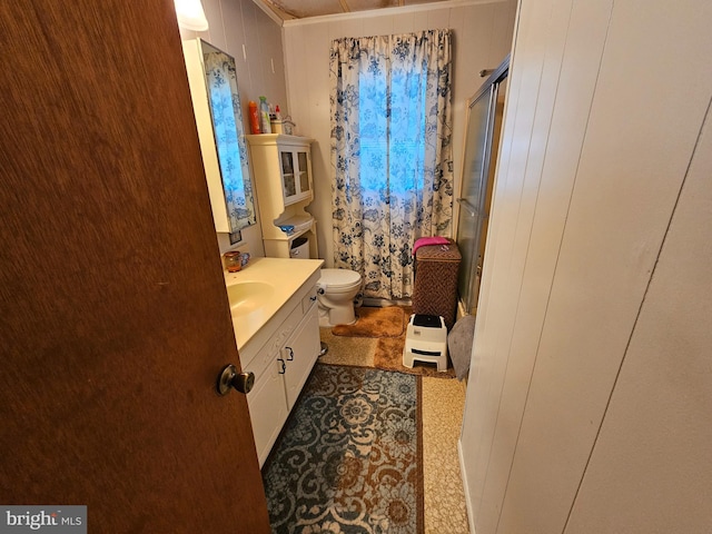 bathroom featuring toilet and vanity with extensive cabinet space