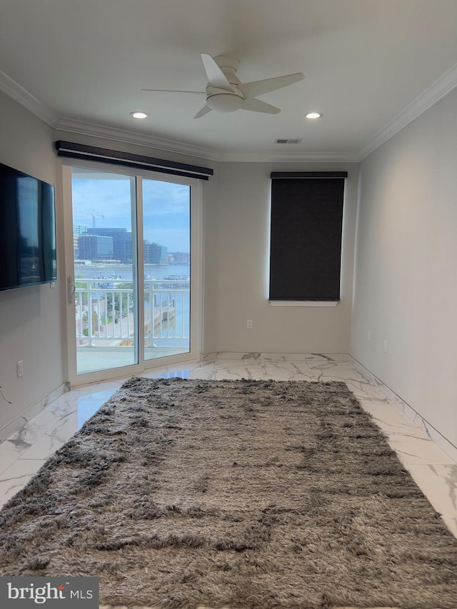 tiled empty room featuring ceiling fan and crown molding