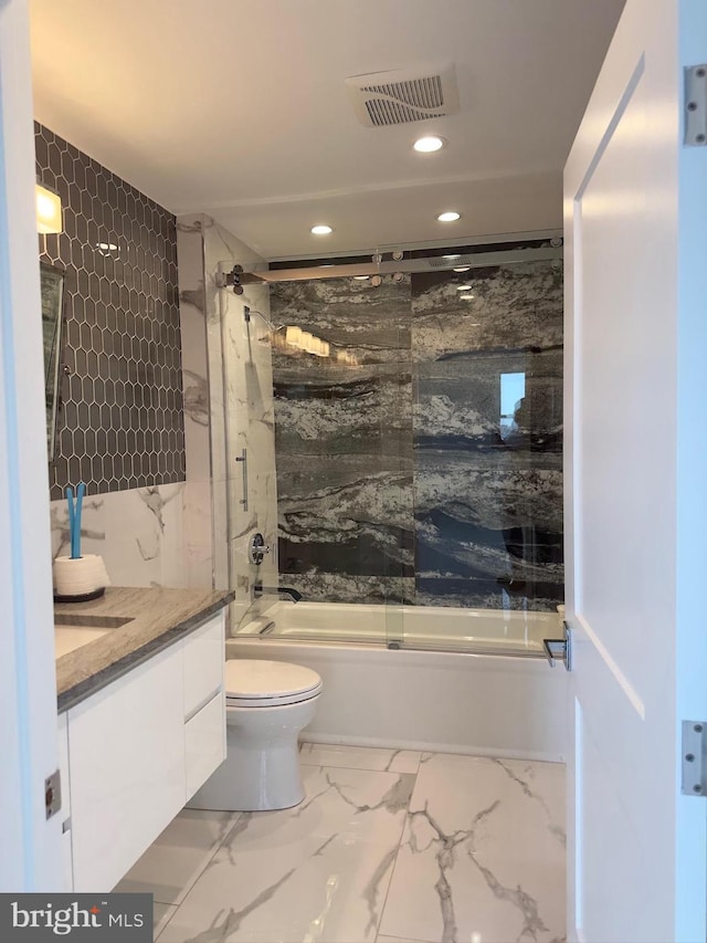 full bathroom with tile floors, enclosed tub / shower combo, toilet, and vanity