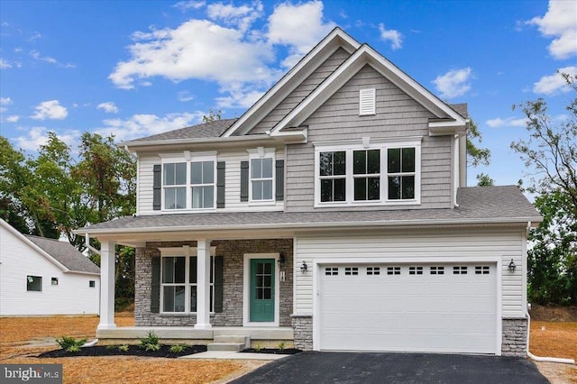 craftsman-style home featuring a porch and a garage