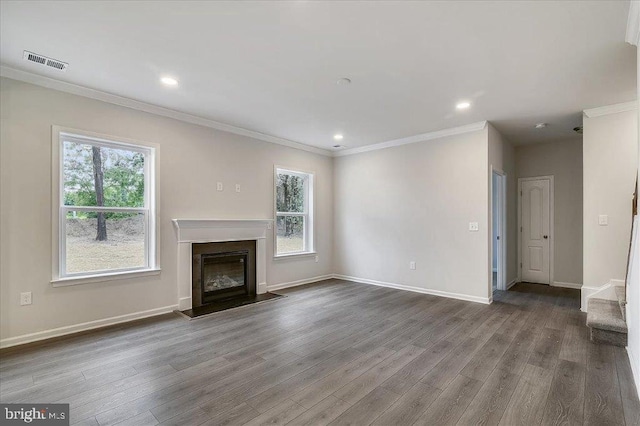 unfurnished living room with wood-type flooring and ornamental molding