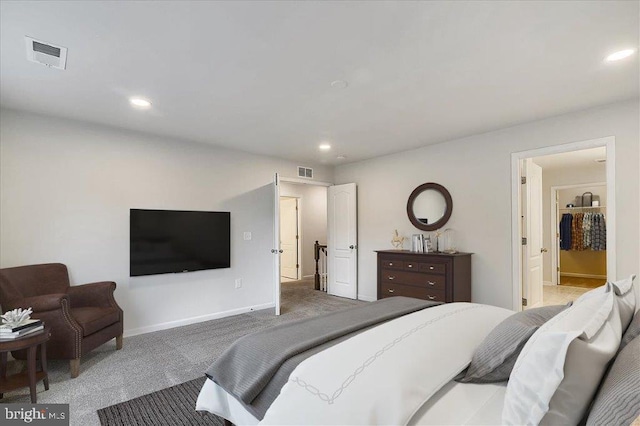 bedroom with dark colored carpet and ensuite bath