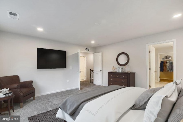 bedroom featuring connected bathroom and dark carpet