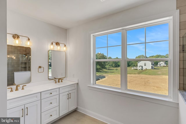 bathroom with double sink, tile floors, and vanity with extensive cabinet space