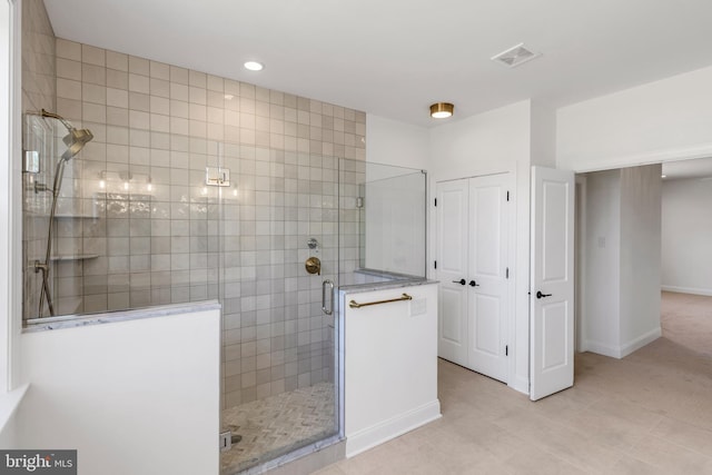 bathroom featuring tile flooring and a shower with door