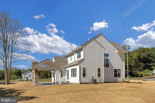 back of house with a lawn