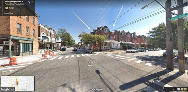 view of road featuring sidewalks, street lighting, a residential view, and curbs