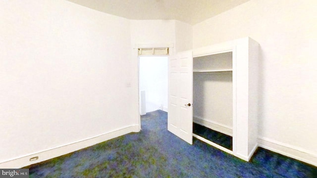 unfurnished bedroom featuring carpet flooring and baseboards