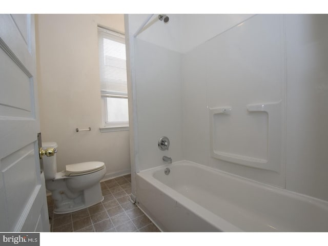 bathroom with tub / shower combination, tile flooring, and toilet