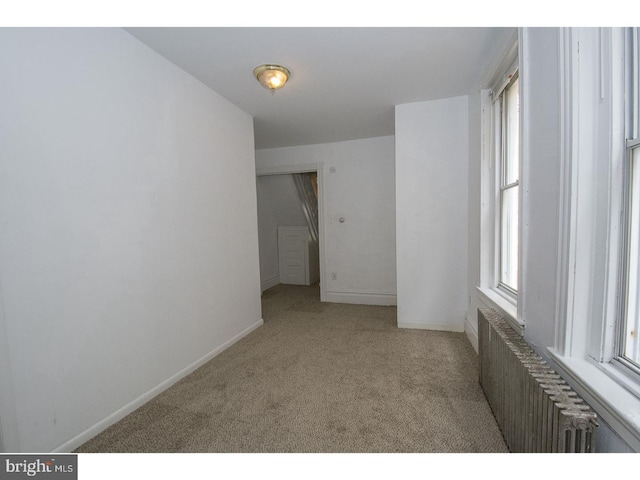 carpeted empty room with radiator