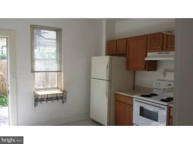 kitchen with white appliances and a healthy amount of sunlight