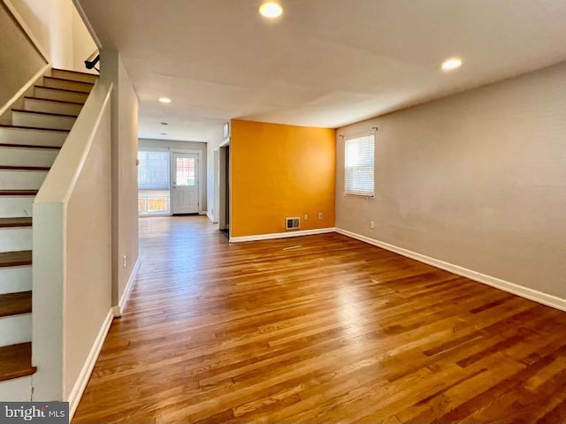 unfurnished living room featuring wood-type flooring