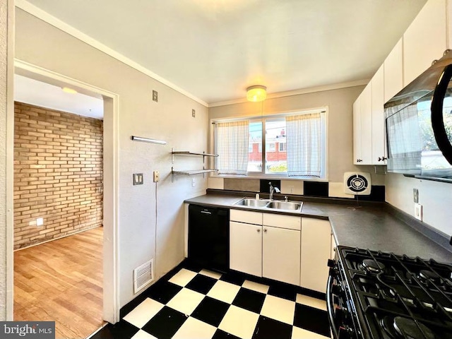 kitchen with white cabinetry, black dishwasher, light tile floors, ornamental molding, and sink