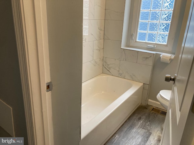 bathroom with toilet and wood-type flooring