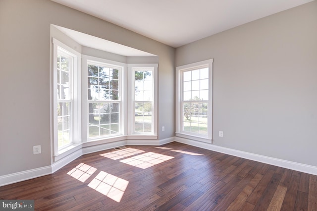 unfurnished room with dark hardwood / wood-style floors