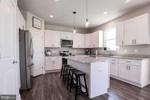 kitchen featuring white cabinetry, a center island, and stainless steel appliances