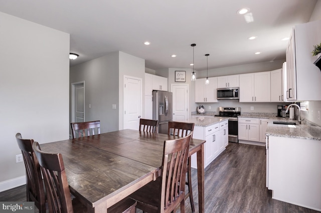 dining space featuring sink and dark hardwood / wood-style floors