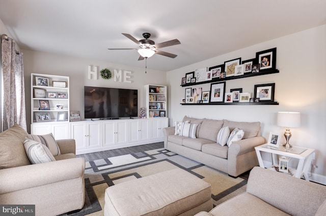 living room with dark hardwood / wood-style floors and ceiling fan