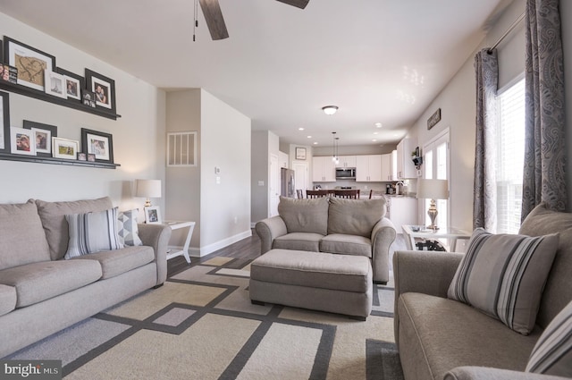 living room with ceiling fan, sink, and hardwood / wood-style flooring