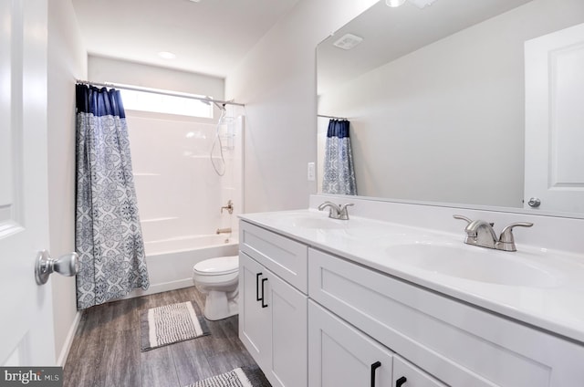 full bathroom featuring hardwood / wood-style floors, vanity, toilet, and shower / bathtub combination with curtain