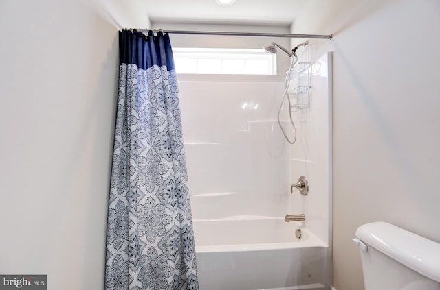 bathroom featuring toilet and shower / tub combo with curtain