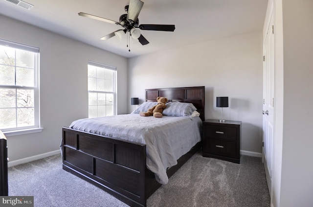 bedroom featuring carpet flooring, multiple windows, and ceiling fan