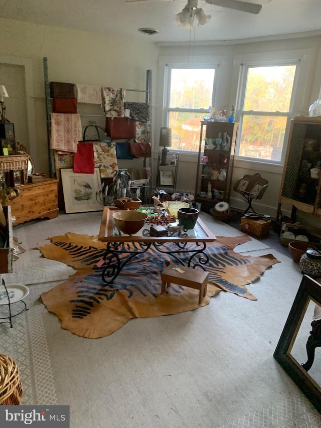 living room featuring light carpet and ceiling fan