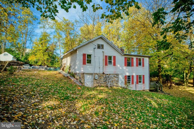 back of property featuring a yard